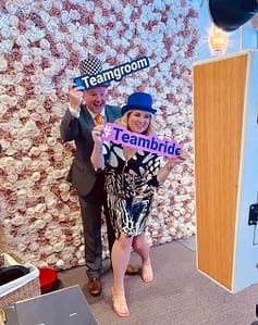 Vintage Selfie Pod. Couple celebrating with fun props